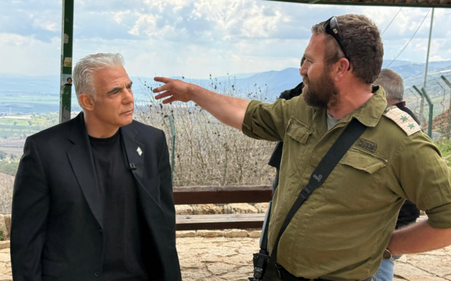 Le chef de l'opposition Yaïr Lapid s'entretient avec un officier de l'armée israélienne, à la frontière nord avec le Liban, le 4 mars 2026. (Crédit : Yesh Atid)