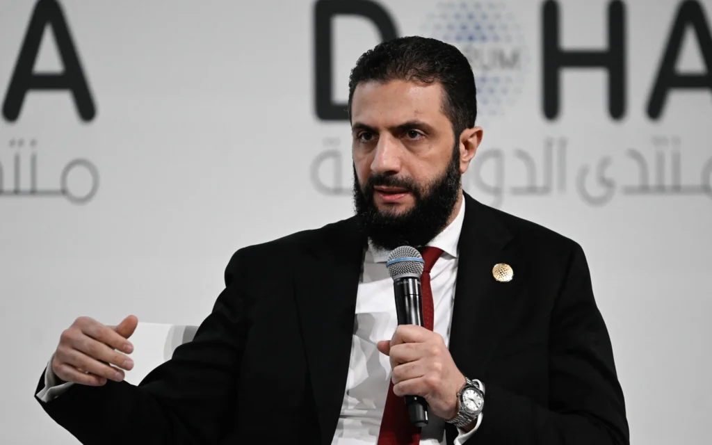 Le président syrien Ahmed al-Sharaa s'exprime lors de la journée d'ouverture du Forum de Doha, une conférence diplomatique annuelle, à Doha, le 6 décembre 2025. (Crédit: Mahmud HAMS / AFP)