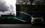 Du ruban de police devant des antennes paraboliques à l'intérieur d'un parc d'entrepôts abritant les bureaux de la chaîne de télévision Iran International à Wembley, au nord-ouest de Londres, le 16 avril 2026. (Crédit : Henry NICHOLLS / AFP)