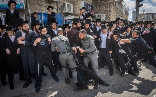 Des juifs ultra-orthodoxes affrontent la police lors d'une manifestation contre la conscription, à Jérusalem, le 12 avril 2026. (Crédit : Chaïm Goldberg/Flash90)