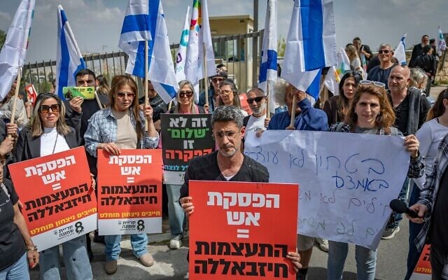 Le maire de Kiryat Shmona, Avichaï Stern (au centre, à l'avant), tenant une pancarte sur laquelle on peut lire « Cessez-le-feu = encouragement du Hezbollah » lors d'une manifestation organisée avec d'autres habitants de cette ville du nord devant l'ambassade des États-Unis, à Jérusalem, le 19 avril 2026. (Crédit : Yonatan Sindel/Flash90)