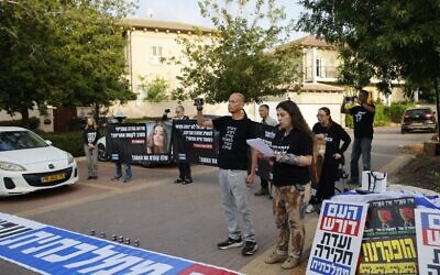 Des familles endeuillées et des membres du Conseil d'octobre manifestant près du domicile du ministre de l'Éducation, Yoav Kisch, à Hod HaSharon, le 19 avril 2026 (Crédit : Ilan Faigenbaum/Groupes de manifestation pro-démocratie)