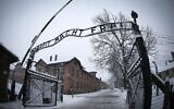 L'entrée de l'ancien camp de concentration nazi d'Auschwitz-Birkenau, sur laquelle figure l'inscription « Arbeit macht frei » (« Le travail rend libre »), à Oświęcim, en Pologne, le 25 janvier 2015, quelques jours avant le 70ᵉ anniversaire de la libération du camp par les forces russes. (Crédit : Joël Saget/AFP)