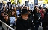 Des personnes tenant des photos des victimes lors d’une cérémonie commémorant le 31ᵉ anniversaire de l’attentat à la bombe contre l’AMIA, qui a fait 85 morts et plus de 300 blessés, à Buenos Aires, en Argentine, le 18 juillet 2025. (Crédit : Luis Robayo/AFP)