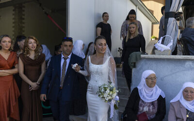 Des invités observent les mariés lors de leur cérémonie de mariage traditionnelle de la communauté circassienne dans la ville de Rehaniya, au nord d'Israël, près de la frontière avec le Liban, le 30 avril 2026. (Crédit : Ilia YEFIMOVICH / AFP) Des invités observent les mariés lors de leur cérémonie de mariage traditionnelle de la communauté circassienne dans la ville de Rehaniya, au nord d'Israël, près de la frontière avec le Liban, le 30 avril 2026. (Crédit : Ilia YEFIMOVICH / AFP)