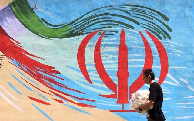 Un Iranien devant une fresque anti-américaine et anti-Israël peinte sur un mur, à Téhéran, en Iran, le 10 mai 2026. (Crédit : Atta Kenare/AFP) Un Iranien devant une fresque anti-américaine et anti-Israël peinte sur un mur, à Téhéran, en Iran, le 10 mai 2026. (Crédit : Atta Kenare/AFP)