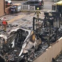 Les épaves d’ambulances calcinées dans un parking, après un incendie criminel visant les véhicules, contrôlés par une association caritative juive, à Golders Green, à Londres, le 23 mars 2026. (AP Photo/Alberto Pezzali)