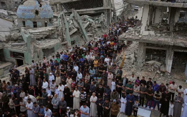 Des Palestiniens prient à l'occasion de l'Aïd al-Adha près des ruines d'une mosquée détruite par les bombardements israéliens, à Khan Younès, dans le sud de la bande de Gaza, le 27 mai 2026. (Crédit: AP Photo/Abdel Kareem Hana)