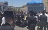 Des Haredim bloquant un bus au poste de contrôle des Tunnels, situé entre le sud de Jérusalem et la Cisjordanie, à la suite de l'arrestation d'un individu soupçonné d'avoir participé à une émeute contre la conscription devant le domicile du juge de la Cour suprême Noam Sohlberg, le 7 juin 2026. (Crédit : Capture d'écran/Moshe Zaide/ZiratNews via X)