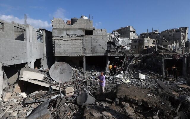 Des Gazaouis inspectant le site d'une frappe israélienne dans le camp de réfugiés de Bureij, au centre de la bande de Gaza, le 16 juillet 2026. (Crédit : Eyad Baba/AFP)