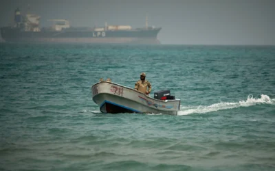 Avec en arrière-plan un méthanier transportant du GPL (gaz de pétrole liquéfié), un soldat yéménite navigue dans les eaux situées au nord du détroit de Bab el-Mandeb, à Mokha, au Yémen, le 6 avril 2026 (Crédit: AP/Abdulnasser Alseddik)