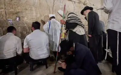 Des hommes juifs ultra-orthodoxes prient pendant le jeûne de Tisha BeAv au mur Occidental, dans la Vieille Ville de Jérusalem, le 22 juillet 2026. (Crédit : Ohad Zwigenberg/AP)