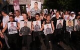 Les proches des pompiers tués lors de l'explosion du port de Beyrouth en 2020 brandissent leurs portraits, alors qu'ils défilent lors d'une cérémonie commémorative marquant le sixième anniversaire de cette gigantesque explosion à Beyrouth, au Liban, le mardi 4 août 2026. (Crédit : AP Photo/Hussein Malla)