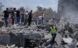 Des habitants et des secouristes rassemblés devant une maison détruite par une frappe aérienne israélienne, dans le village de Deir al-Zahrani, au sud du Liban, le 15 août 2026. (Crédit : Mohammed Zaatari/AP)