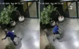 Un homme masqué filmé par une caméra de surveillance alors qu’il lance une brique contre les portes vitrées des bureaux de la chaîne N12 à Tel Aviv, aux premières heures du 28 juillet 2026. (Crédit : N12/X)