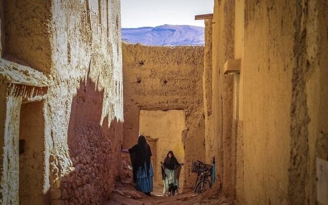 Des femmes discutent dans le quartier juif, ou « mellah », du village de Tagadirt, dans la région des oasis de Tata au Maroc, le 28 février 2023. (Crédit : Fadel Senna/AFP)