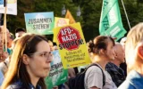 Une banderole sur laquelle on peut lire « Stop AfD Nazis » brandie lors d'une manifestation contre la montée en puissance du parti d'extrême-droite « Alternative pour l'Allemagne » (AfD), devant la Porte de Brandebourg, à Berlin, le 7 septembre 2026. (Crédit : Emmanuele Contini/NurPhoto via Getty Images via JTA)