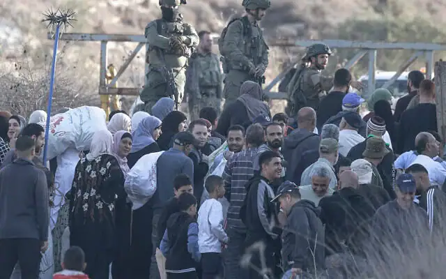 Des soldats israéliens interceptant des agriculteurs palestiniens du village de Salem à un poste de contrôle, avant qu'ils ne franchissent un portail fermé pour accéder à leurs terres afin d'y cueillir des olives, à l'est de Naplouse, en Cisjordanie, le 22 novembre 2025. (Crédit : Jaafar Ashtiyeh/AFP) Des soldats israéliens interceptant des agriculteurs palestiniens du village de Salem à un poste de contrôle, avant qu'ils ne franchissent un portail fermé pour accéder à leurs terres afin d'y cueillir des olives, à l'est de Naplouse, en Cisjordanie, le 22 novembre 2025. (Crédit : Jaafar Ashtiyeh/AFP)