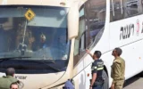 Des membres des forces de sécurité et des services d'urgence israéliens inspectent les lieux d'une attaque à la arme à feu sur un bus transportant des soldats dans la vallée du Jourdain, le 4 septembre 2022. (Ahmad Gharabli/AFP)