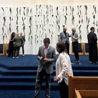 Les fidèles se réunissent à la congrégation Beth El pour faire leurs adieux à "The White Flame of the Six Million", une sculpture de la célèbre artiste Louise Nevelson qui servait de bimah, à Great Neck, dans l’État de New York, le 1er octobre 2026. (Crédit : Michelle Falkenstein/JTA)