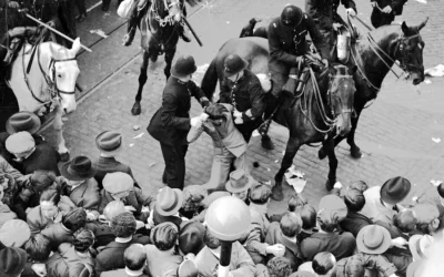 Un manifestant est arrêté et emmené par des policiers après un matraquage à cheval, dans l'East London, le 4 octobre 1936, pour mettre fin aux affrontements entre anti-fascistes et les Chemises noires de Sir Oswald Mosley. (Photo AP/Worth)