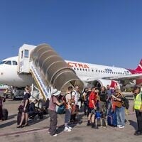 Des voyageurs débarquent d'un avion Electra à l'aéroport international Ben Gurion, le 8 septembre 2025. (Crédit : Yossi Aloni/FLASH90)