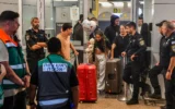 Des passagers du vol FZ1073 de flydubai traversent le hall des arrivées de l'aéroport international Ben Gurion, après que leur vol initial reliant Dubaï à Israël a effectué un atterrissage d'urgence en Arabie saoudite à la suite d'un attentat terroriste perpétré par le copilote, qui a attaqué le commandant de bord et tenté de faire s'écraser l'avion, le 30 septembre 2026. (Crédit : Avshalom Sassoni/Flash90)