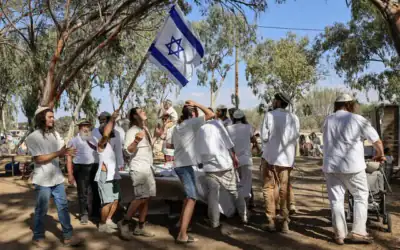 Des fidèles célèbrent la fête juive de Simhat Torah sur le site du festival de musique Nova, à l'endroit où des centaines de personnes ont été assassinées par le Hamas lors du pogrom du 7-octobre, près du kibboutz Reim, dans le sud d'Israël, le 3 octobre 2026. (Tsafrir Abayov/Flash90)