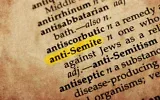 Le mot « antisémite » dans un ancien dictionnaire à la couverture texturée. Illustration. (Crédit : goglik83/iStock via Getty Images)