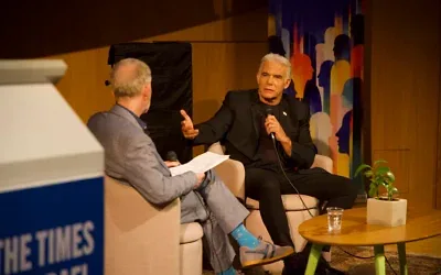 Le chef de l’opposition Yair Lapid, à droite, s’entretient avec David Horovitz, rédacteur en chef et fondateur du Times of Israel, à Tel Aviv, le 12 octobre 2026. (Crédit: Times of Israel)