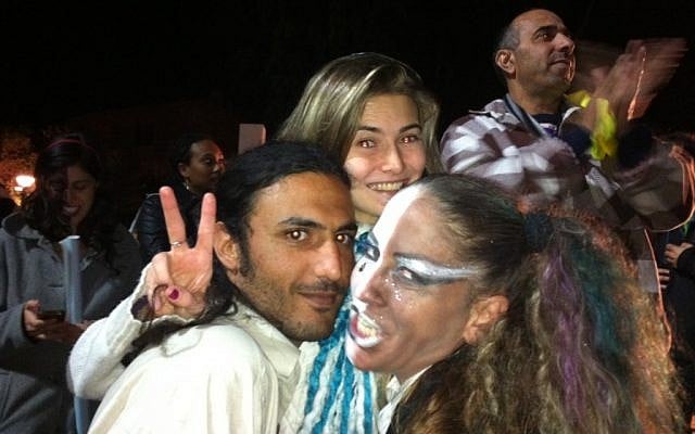 Eddie Gabai, in glasses, painted her face in black and white to portray the unity of all Israelis. She told TOI that she regularly dresses up according to a rally's theme. (photo credit: Michal Shmulovich)