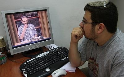 A student at Jerusalem's Yeshiva Machon Meir takes a virtual Torah class over the Internet. (Photo by Nati Shohat/Flash90)