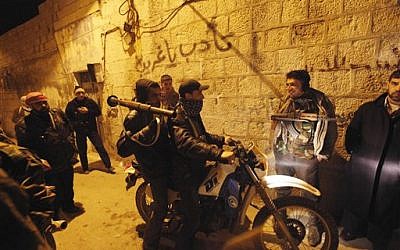 Syrian rebels secure a demonstration in Idlib Saturday (photo credit: AP)