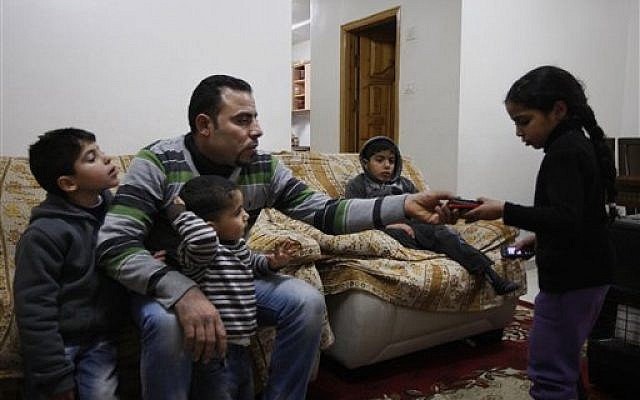 Hussein al-Ustaz with his childrens (photo credit: Majdi Mohammed/AP)