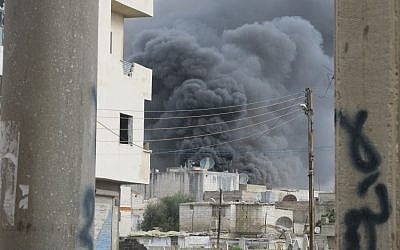 Homs burns under Assad's bombardment (photo credit: CC BY FreedomHouse, Flickr)