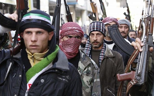 Syrian rebels march in a show of strength during a demonstration in Idlib, Syria (photo credit: AP) Syrian rebels march in a show of strength during a demonstration in Idlib, Syria (photo credit: AP)