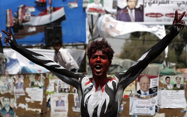 A protestor with Yemen's flag painted on his body shouts slogans during a rally demanding the prosecution of Yemen's former president Ali Abdullah Saleh, in Sanaa, Yemen, Wednesday (photo credit: AP Photo/Hanoi Mohammed)