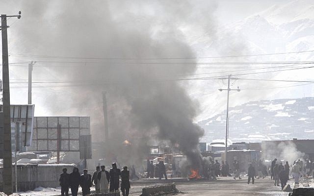 Smoke rises into the sky from tires burnt by protesters during an anti-US demonstration in Kabul on Wednesday (photo: AP/Musadeq Sadeq)