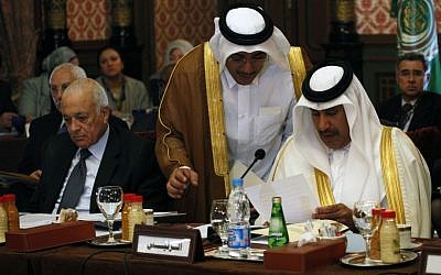 Arab League chief Nabil Elaraby, left, and Qatari Prime Minister Sheikh Hamad Bin Jassim Althani, right, are seen during a meeting in Cairo, September 1, 2013. (Photo credit: AP/Nasser Nasser)