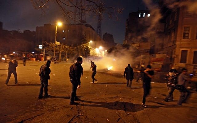 Egyptian protesters flee police on Thursday (photo credit: AP Photo/Khalil Hamra)