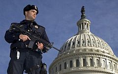 A Capitol Police officer stands guard in front of the US Capitol (photo credit: AP Photo/Manuel Balce Ceneta)