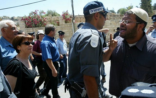 Meretz MK Zehava Gal-on walks in Hebron as right-wing activist Itamar Ben-Gvir shouts in a confrontation in June 2008 (photo credit: Olivier Fitoussi/Flash90)