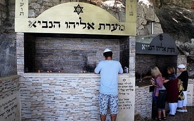 Israelis light candles at Elijah's cave, next to Haifa (photo credit: Matanya Tausig/Flash90)