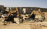 Caterpillar manufactured equipment at work in the West Bank (photo credit: Gershon Elinson/Flash90)