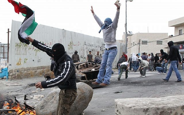 Stone throwing Palestinians clash with Israeli troops in East Jerusalem in 2011 (photo credit: Nati Shohat/Flash90)