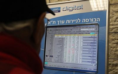 A man looks at screen listing prices of the Tel Aviv Stock Exchange (illustrative photo credit: Yossi Zamir/Flash 90)