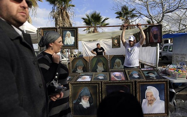 A vendor sells pictures during the annual pilgrimage to the tomb of Rabbi Abuhatzeira in 2012 (photo credit: Tsafrir Abayov/Flash90) A vendor sells pictures during the annual pilgrimage to the tomb of Rabbi Abuhatzeira in 2012 (photo credit: Tsafrir Abayov/Flash90)