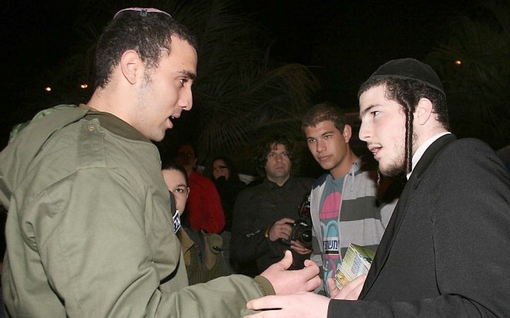 An Orthodox soldier and an ultra-Orthodox Israeli. (photo credit: Gideon Markowicz/Flash90)