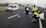 This photo supplied by Zaka shows members of the organization at the scene of a hit-and-run accident in northern Israel early Friday morning. (photo credit: Zaka / Flash90)
