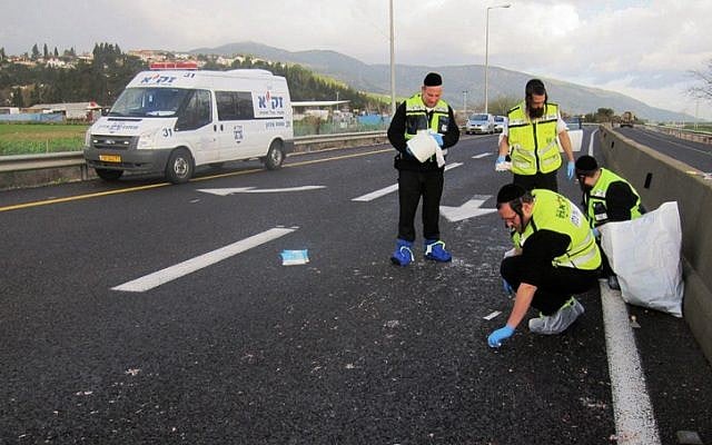 This photo supplied by Zaka shows members of the organization at the scene of a hit-and-run accident in northern Israel early Friday morning. (photo credit: Zaka / Flash90)
